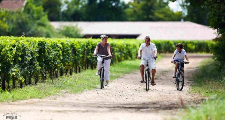 photo d'une famille à vélo dans les vignes de Bordeaux
